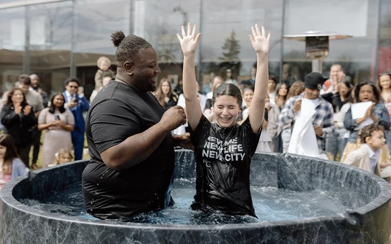 A pastor baptizing a junior high student during an Easter service at New City Church in Naperville.